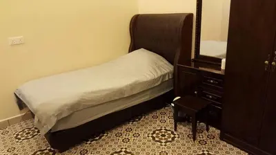 a bedroom with a bed and a dresser and a mirror at Golden Hill 34 in Cameron Highlands