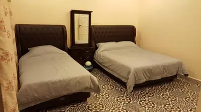 a bedroom with two beds and a mirror at Golden Hill 34 in Cameron Highlands