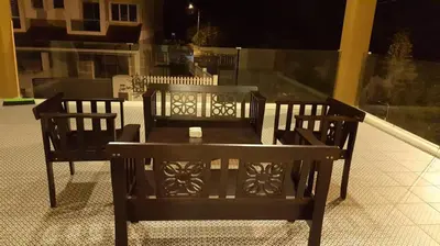 a table and chairs on a balcony at night at Golden Hill 34 in Cameron Highlands