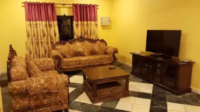 a living room with a couch and a flat screen tv at Golden Hill 34 in Cameron Highlands