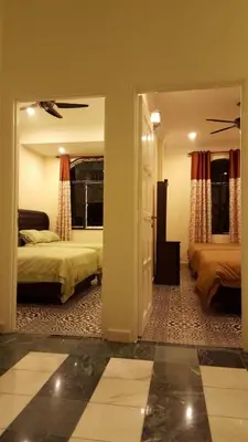 a large room with two beds and a doorway at Golden Hill 34 in Cameron Highlands