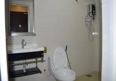 a bathroom with a toilet and a sink and a shower at Angsoka Hotel in Teluk Intan