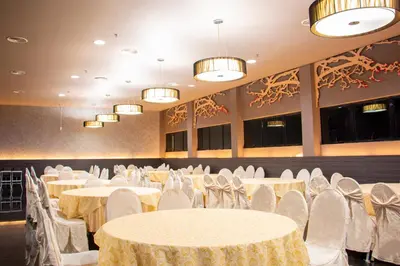 a banquet hall with white tables and chairs at Flemington Hotel in Taiping