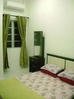 a bedroom with a bed and a mirror and a window at Homestay Amsyarah in Seri Iskandar