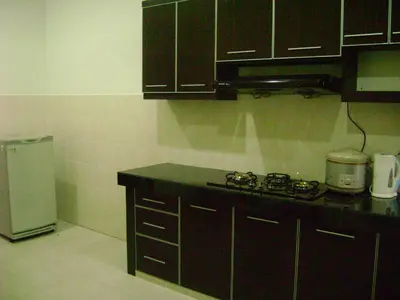 a kitchen with a stove and a refrigerator at Homestay Amsyarah in Seri Iskandar