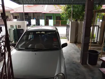 a white car parked in the driveway of a house at Homestay Amsyarah in Seri Iskandar