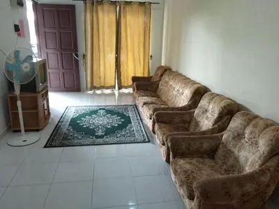 a living room with a couch and a tv at Homestay Amsyarah in Seri Iskandar