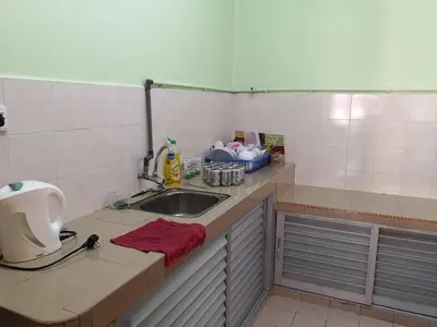 a kitchen with a sink and a counter top at Kelly Cozy cottage in Kampar