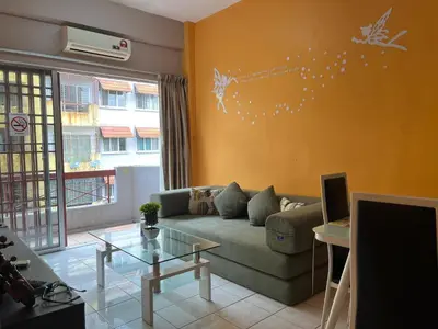 a living room with a couch and a table at Kelly Cozy cottage in Kampar