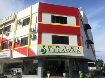 a red and white building with a sign on it at Hotel Sitiawan in Sitiawan