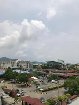 a city with a parking lot and a building at Kangsar Hotel in Kuala Kangsar