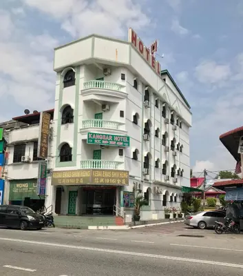 a large white building with a sign on it at Kangsar Hotel in Kuala Kangsar