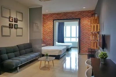 a living room with a couch and a bed at PM Octagon Ipoh Suites & Apartment 2 in Ipoh