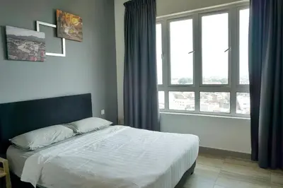 a bedroom with a bed and a large window at PM Octagon Ipoh Suites & Apartment 2 in Ipoh
