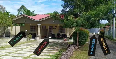 a house with signs in front of it at The Retreat Homestay in Tanjung Malim
