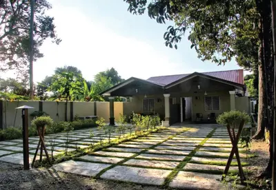 a house with a stone walkway in front of it at The Retreat Homestay in Tanjung Malim