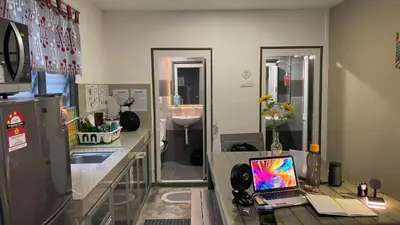 a kitchen with a desk with a laptop on it at The Retreat Homestay in Tanjung Malim