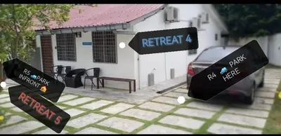 a car parked in front of a white building at The Retreat Homestay in Tanjung Malim