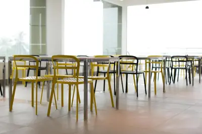 a row of tables and chairs in a room at Marina Heights Resort in Lumut