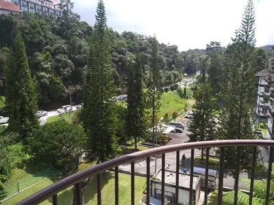 a balcony with a view of a street and trees at Tenggafriz holidays in Cameron Highlands