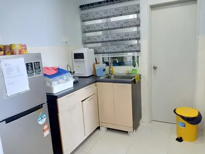 a small kitchen with a sink and a refrigerator at Sekinchan SeaView Homestay 134 \u9ad8\u697c\u770b\u6d77\u9633\u53f0\u6c11\u5bbf in Sekincan