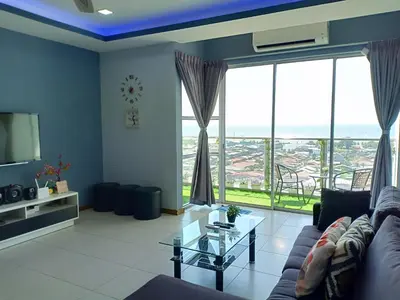 a living room with a couch and a glass table at Sekinchan SeaView Homestay 134 \u9ad8\u697c\u770b\u6d77\u9633\u53f0\u6c11\u5bbf in Sekincan
