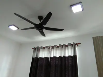 a ceiling fan on a room with a shower curtain at NAUFAL MUSLIM'S HOMESTAY in Cameron Highlands