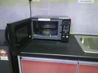a microwave sitting on top of a kitchen counter at NAUFAL MUSLIM'S HOMESTAY in Cameron Highlands