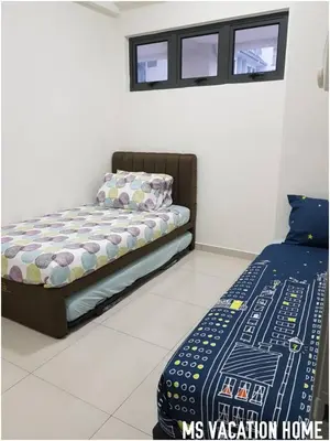 a bedroom with a bed and two windows at MS Vacation Home (Muslim Homestay) in Cameron Highlands