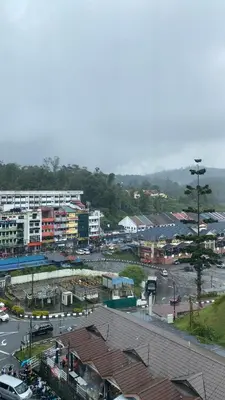 a city with a parking lot with cars and buildings at MS Vacation Home (Muslim Homestay) in Cameron Highlands