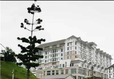 a large building with a tree in front of it at MS Vacation Home (Muslim Homestay) in Cameron Highlands