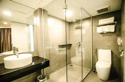 a bathroom with a toilet and a sink and a shower at Hotel Sfera in Lumut