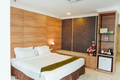 a bedroom with a large bed in a room at Hotel Sfera in Lumut