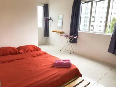 a bedroom with a bed with a red blanket at CH Homestay in Cameron Highlands