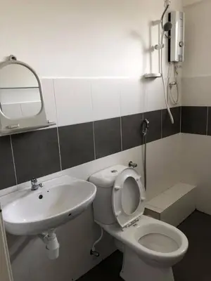 a bathroom with a white toilet and a sink at CH Homestay in Cameron Highlands