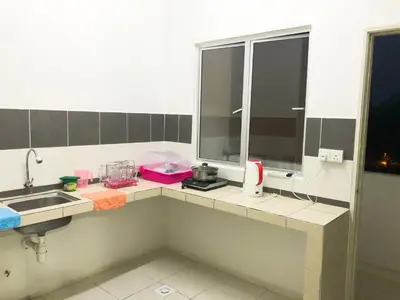 a kitchen counter with a sink and a window at CH Homestay in Cameron Highlands