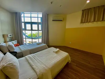a hotel room with two beds and a window at Chariton Hotel Butterworth in Butterworth