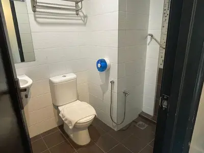 a bathroom with a toilet and a sink at Chariton Hotel Butterworth in Butterworth