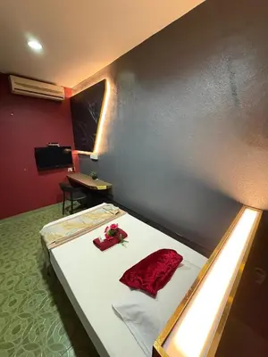 a bedroom with a bed with red pillows on it at Weng Kong Hotel in Slim River