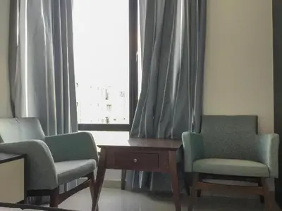 two chairs and a table in a room with a window at The Meadow Park in Kampar