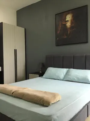 a bed with a pillow on it in a bedroom at The Meadow Park in Kampar