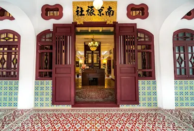 an open door to a building with a tile floor at Nam Keng Hotel Penang in George Town