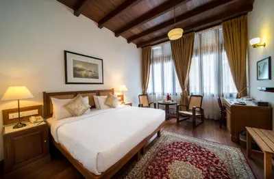 a bedroom with a large white bed and a desk at Nam Keng Hotel Penang in George Town