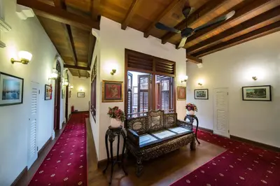 a hallway with a bench in a house at Nam Keng Hotel Penang in George Town