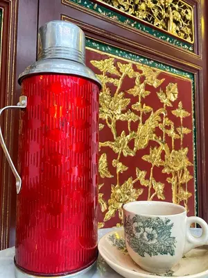 a red fire hydrant sitting next to a cup at Nam Keng Hotel Penang in George Town