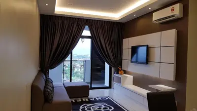 a living room with a large window and a tv at Oasis Condominium in Ipoh