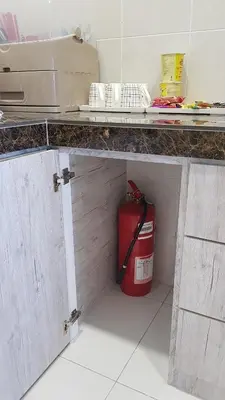 a kitchen with a red trash can under a counter at Oasis Condominium in Ipoh