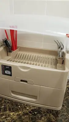 a large white appliance sitting on a counter with utensils at Oasis Condominium in Ipoh
