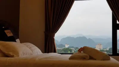 a hotel room with a bed with a window at Oasis Condominium in Ipoh
