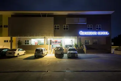 a car dealership with cars parked in a parking lot at Chariton Hotel Ipoh in Ipoh